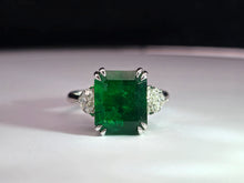 Load image into Gallery viewer, 4.02ct Emerald Cut Green Emerald | 0.47cts [2] Heart Shaped Diamond | Designer Trilogy Ring | 18kt White Gold
