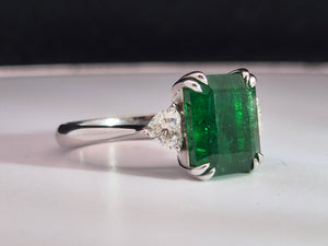 4.02ct Emerald Cut Green Emerald | 0.47cts [2] Heart Shaped Diamond | Designer Trilogy Ring | 18kt White Gold